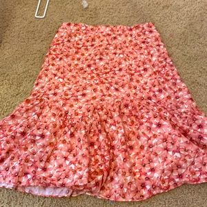 Midi pink floral skirt with bottom flare. It's not stretchy like at all.